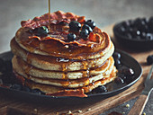 Pancakes with blueberries, bacon and syrup