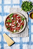 Classic beef carpaccio with cheese and arugula