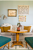 Pedestal table in living room decorated with flea-market finds