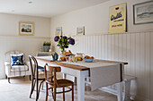 Table in front of wainscoting in a rustic dining room