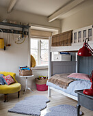 Country-house-style children's bedroom with bunk beds and accents of colour