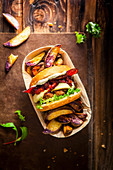 Plum and bacon burger with thyme and potato slices