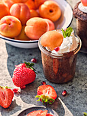 Chocolate mugcake in a glass with cream and apricots