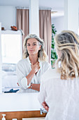 Woman looking at herself in a mirror