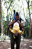 Playful father holding daughter upside down