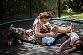 Mother and daughters playing