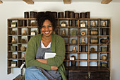 Portrait confident female shop owner at vintage display