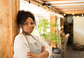 Portrait confident female shop owner in plant nursery