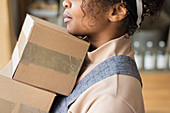Close up female shop owner with cardboard boxes
