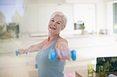 Portrait senior woman exercising with dumbbells