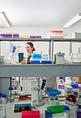 Female scientist with specimen tray in laboratory