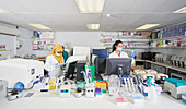 Female scientists in face masks working in laboratory