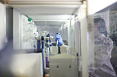 Female scientist using pipette at fume hood in laboratory