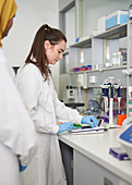 Female scientists using equipment in laboratory