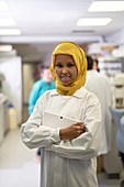 Portrait confident scientist in hijab in laboratory