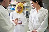 Scientists with specimen tray in laboratory