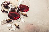 Rotwein in Gläsern, Ziegenkäse und Trauben