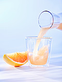 Pouring grapefruit juice into a glass