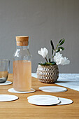 Carafe on cut out paper circles used as coasters