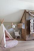 Play tent, chair and wooden cubby bed in child's bedroom