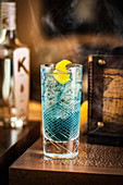 Blue cocktail with lemon peel