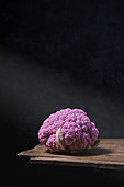 Purple cauliflower on wooden table