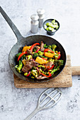 Sweet and sour beef stir fry with edamame, peppers and broccoli