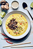 Asian cream soup with noodles and mushrooms