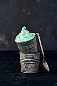 Green mint ice cream in metal bucket