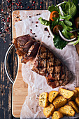 Grilled beefsteak with potatoes and salad