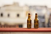 Zwei Bierflaschen auf Balkonbrüstung