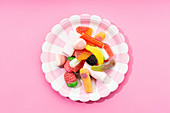 Multicolored gummy candies on striped plate