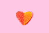 Heart shaped jelly candy on pink surface