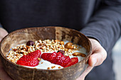 Bowl of yoghurt and granola with strawberries