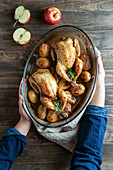 Roasted young chickens with potatoes and apples