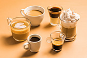 Different classic kinds of coffee drinks served in cups of various sizes