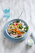 Exotic rice salad with vegetables and pineapple on plate