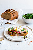 Open sandwich with poached eggs, radish and cucumber