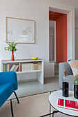 View past coffee table to sideboard with books on shelf