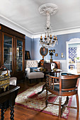 Antiques in classic living room with blue walls