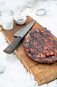 Grilled flank steak on wooden board