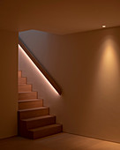 Modern staircase with indirect lighting behind handrail