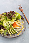 Mixed leaf salad with avocado and pears