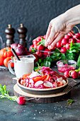 Radish tomato salad with red onions and sour cream