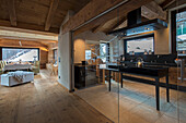 Custom kitchen behind glass wall with doors