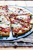 Close up of pizza with herbs and cheese