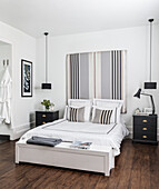 Striped bed headboard in masculine bedroom in black and white