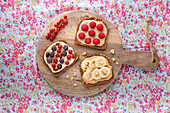A trio of sweet spreads on bread with fruit