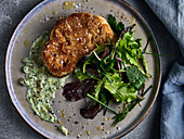Cauliflower schnitzel with lettuce and herb sauce