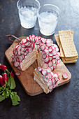 Cheese ball 'mille feuille' with radish and poppy seed